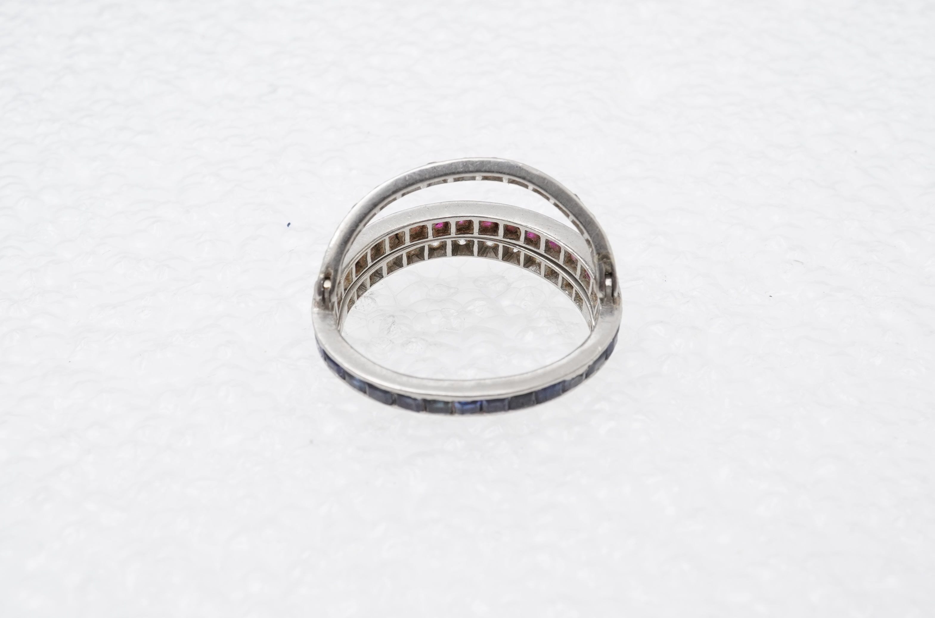 A ruby, sapphire and diamond 'Day and Night' ring, mid 20th century